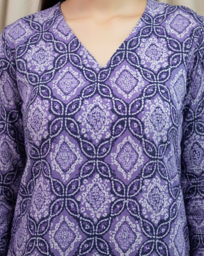 Purple patterned shirt worn by a person, with a neutral background